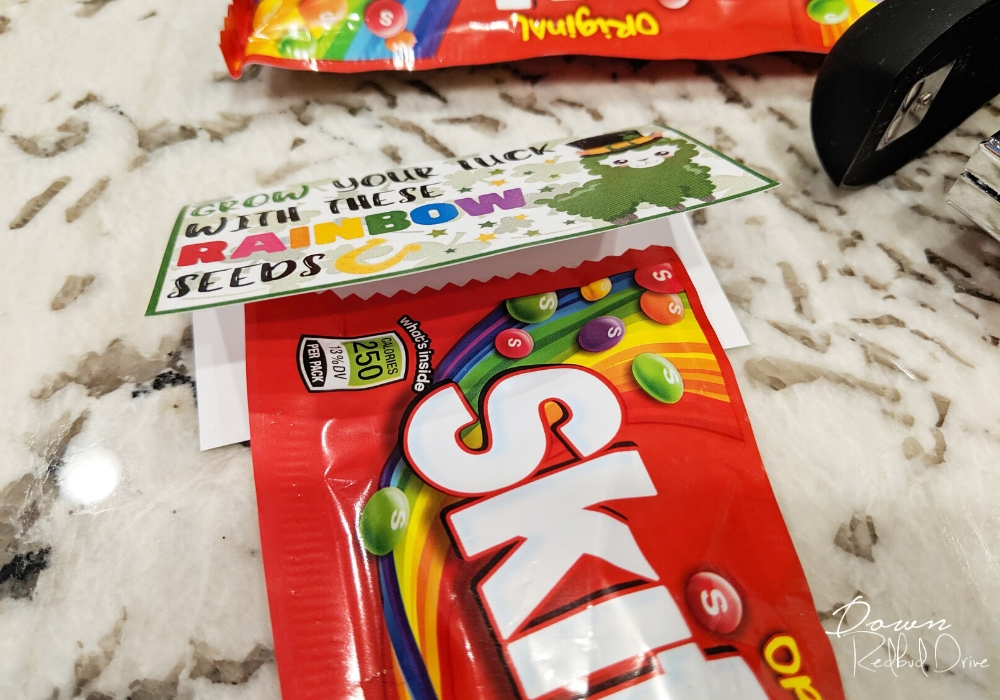 lining up Skittles on a Rainbow Seeds label