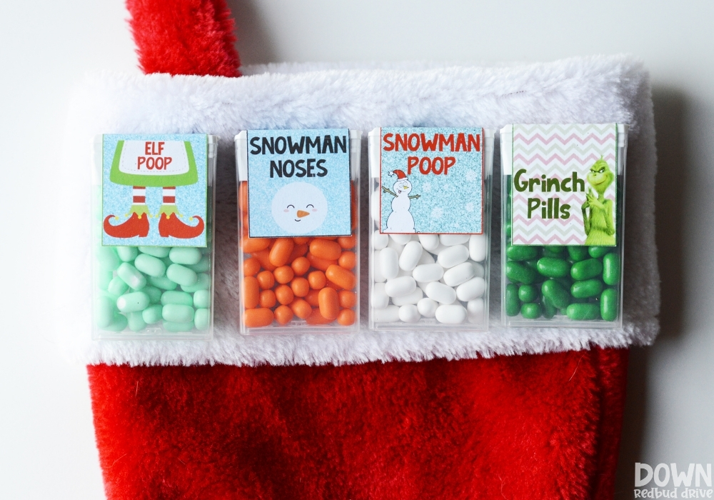 All 4 Christmas Tic Tac Gifts in a row on the top of a Christmas stocking.