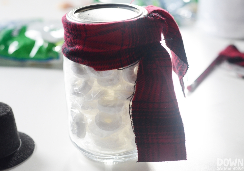 A plaid scarf added to the mason jar full of lifesavers.