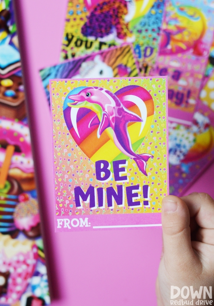 Tall image of a child holding a valentine that says "Be mine!"