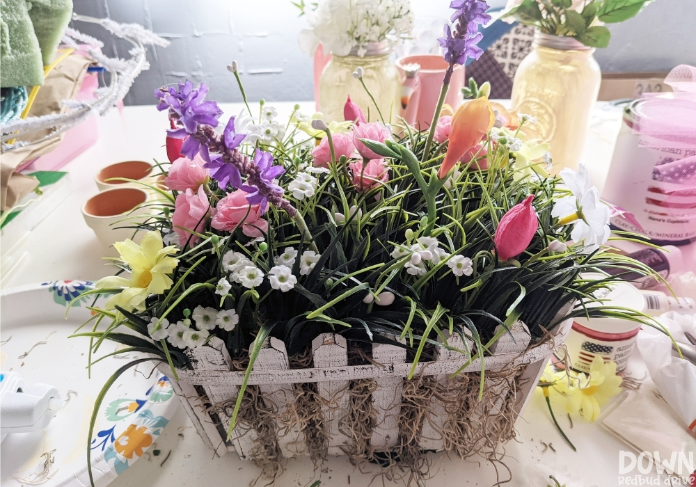 Flowers added to the spring floral centerpiece.