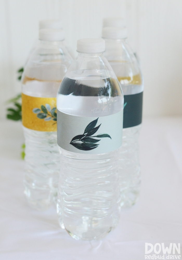 Close up tall image of the greenery themed water bottles.