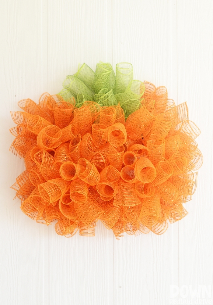 A tall closeup of the DIY Mesh Pumpkin Wreath.