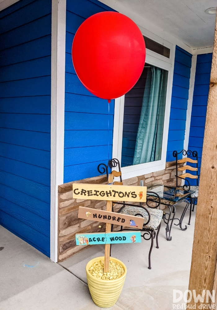 An outdoor Winnie The Pooh themed sign that say's "Creighton's Hundred Acre Wood".