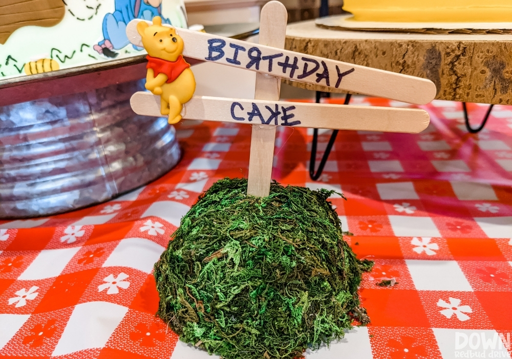 Close up of the Winnie the Pooh themed birthday cake sign.