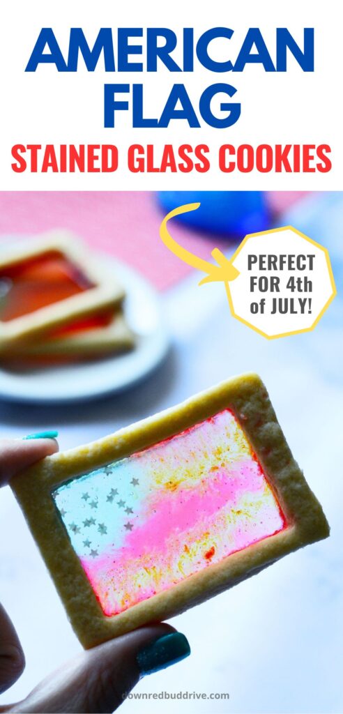 Finished American Flag stained glass cookie being held to the light, a plate of additional cookies in the distance with text overlay that says american flag stained glass cookies perfect for 4th of july