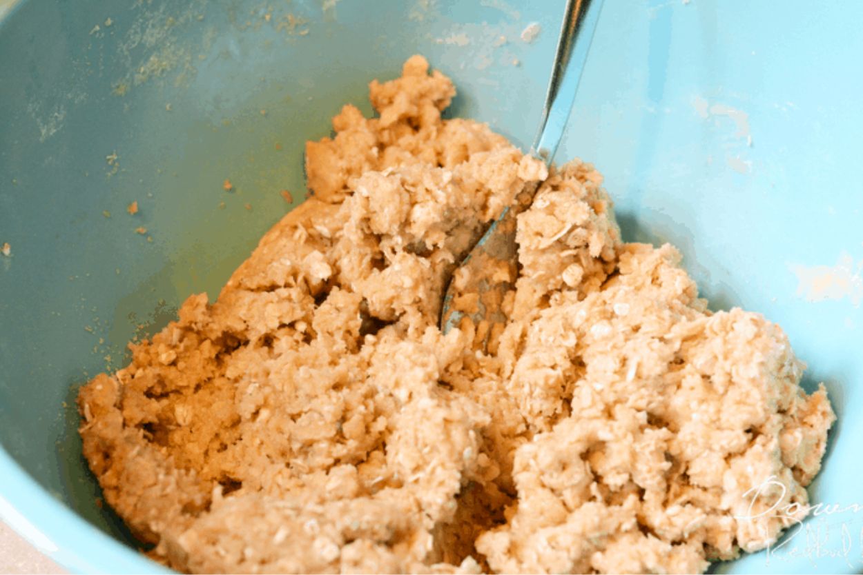 zucchini crisp topping in a blue bowl, mixed and ready to spread
