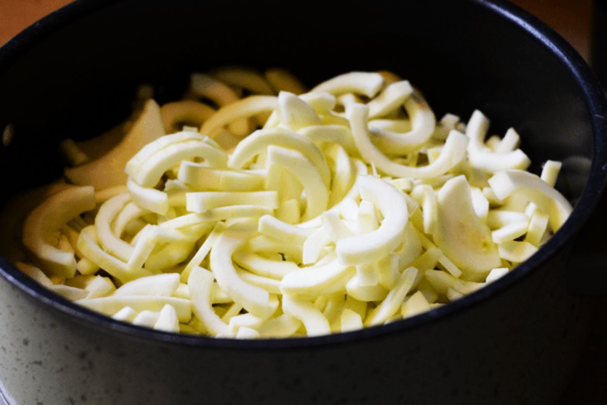 Sliced zucchini made to look like apple slices in a pot ready for boiling