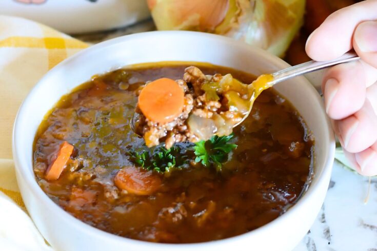 close up of finished hamburger soup in a white bowl