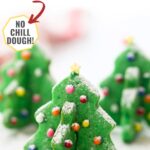 3 finished 3d christmas tree cookies decorated with sprinkles to look like ornaments with a text overlay that says stand up christmas tree sugar cookies no chill dough