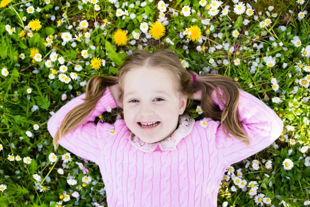 girl with dandelions in a field 